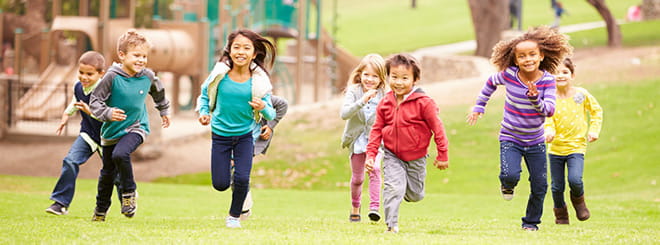 Group of kids running together in the park